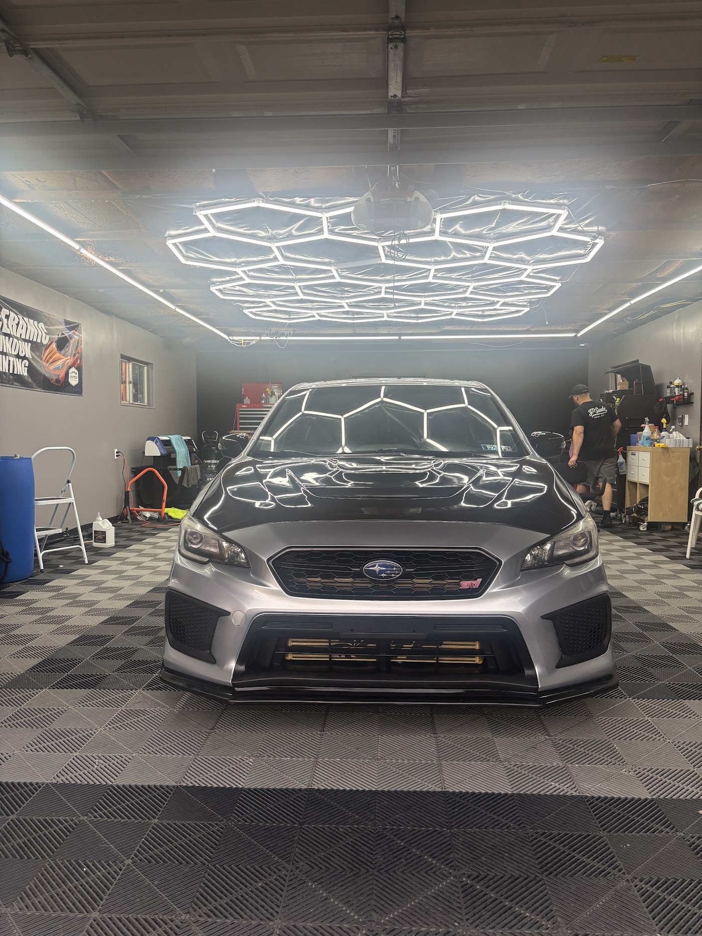 Subaru WRX under the studio lights after a full detail